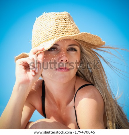 Excited mid adult woman enjoying the sun on a beach
