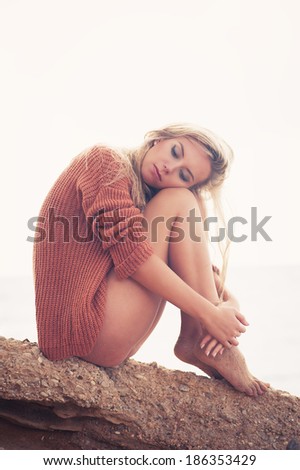 sexy girl poses on a beach