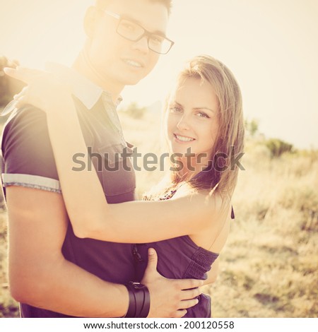 Stunning sensual outdoor portrait of young stylish fashion couple  in summer. Photo with instagram style filters