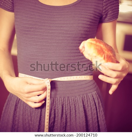 young woman holds pie and a measuring tape, care about health. Photo with instagram style filters