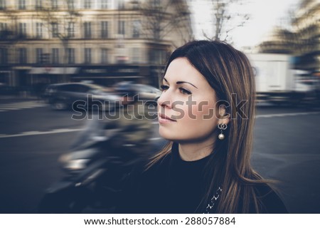 Beautiful brunette girl in casual clothes walking around the city. Fashion and city style.
