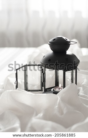 black lantern with candle at table, living room design