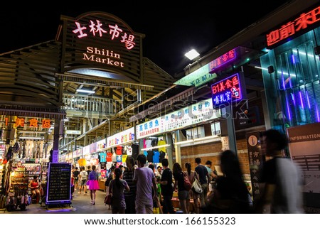 TAIPEI, TAIWAN - JULY 14: Crowds flock to the entrance of Shilin Night Market in the Shilin District of Taipei July 14, 2013. Shilin Market is the most popular and largest night market in Taiwan.