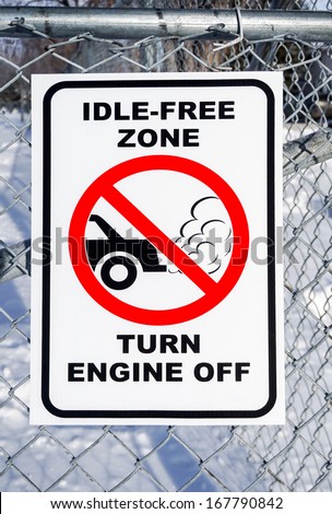Idle-Free Zone, Turn Engine Off Sign on a Fence