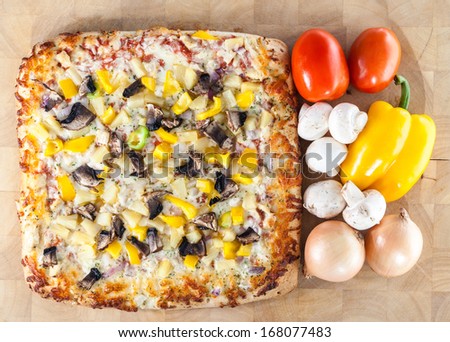 Freshly baked pizza topped with seasoned chicken, mushroom, peppers, onion and cheese