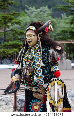 BANFF, CANADA - JUL 3: A native Blackfoot Indian chief wearing a split-horn bison bonnet dances during a performance at the Banff Summer Arts festival July 3, 2014.