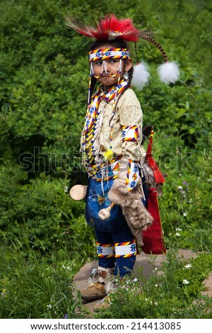 BANFF, CANADA - JUL 3: A young native Blackfoot Indian dancer gets ready for her performance during the Banff Summer Arts festival July 3, 2014. It is the longest running arts festival in Canada.