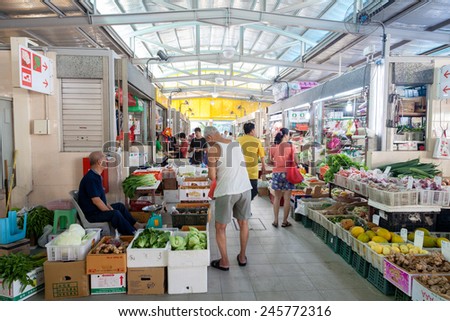 SINGAPORE - DECEMBER 11: Local residents shopping for fruits and vegetables at a local wet market Dec. 11, 2014, in Singapore. A wet market is the place to buy groceries and the freshest produce.