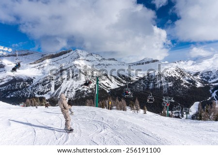 LAKE LOUISE, CANADA - FEBRUARY 14: Skiers descend the slopes at Lake Louise Feb. 14, 2015. Lake Louise is a popular ski resort in Banff National Park, Canada.