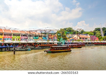 Colorful bars and restaurants dot the Singapore River along Clarke Quay. Once a warehouse, the area is now converted into a popular meeting place for locals and tourists alike. HDR rendering.