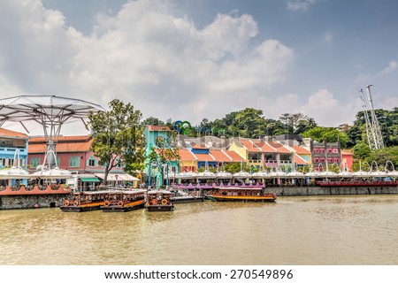 SINGAPORE - MARCH 18: Colorful bars and restaurants dot the Singapore River along Clarke Quay Mar. 18, 2015. The area used to be a commercial center during the colonial era. HDR rendering.