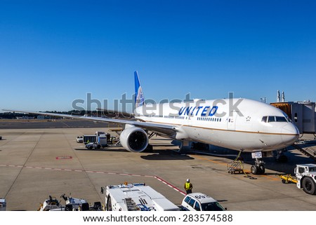 TOKYO - DECEMBER 5: A United Airlines plane being serviced on the tarmac of Narita Airport Dec. 5, 2014. After its merger with Continental in 2010, United has become the world\'s largest airline.