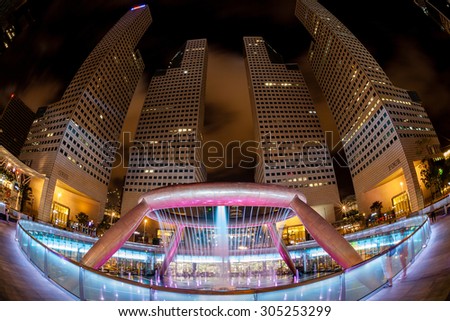 SINGAPORE - JULY 18: The Fountain of Wealth illuminates at night July 18, 2015. Built in 1995 as a symbol of wealth and life, it is the largest fountain in the world.