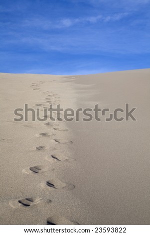 A trail of footprints leading over a sand dune in Colorado. Great Sand Dune National Park.