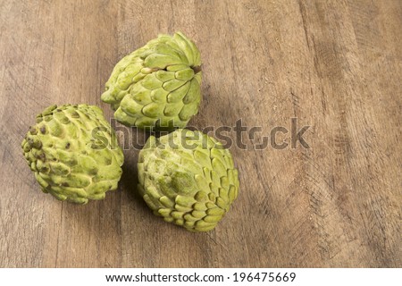 Some Sugar-Apples over a wooden table