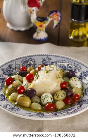 A typical Portuguese dish with codfish called Bacalhau do Porto in a original portuguese plate.