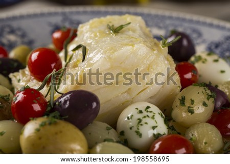 A close up of a typical Portuguese dish with codfish called Bacalhau do Porto in a original portuguese plate.