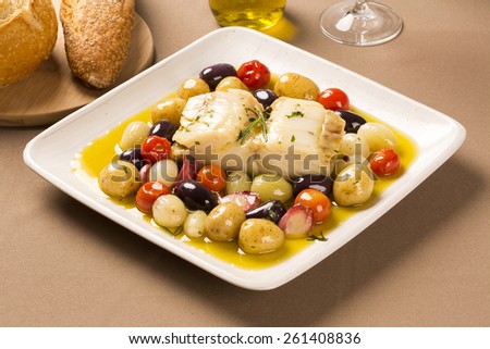 A typical Portuguese dish with codfish called Bacalhau do Porto in a original portuguese plate