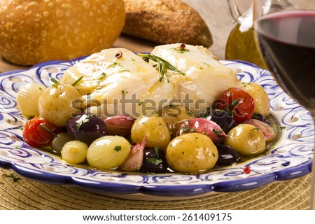 A typical Portuguese dish with codfish called Bacalhau do Porto in a original portuguese plate