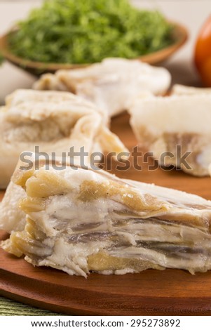 Raw pig tails on wooden background