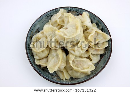 one plate of chinese food boiled dumplings closeup photograph isolated on white background