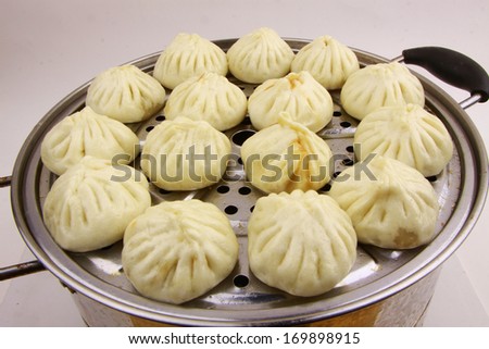 chinese food steamed stuffed bun closeup photograph isolated on white background