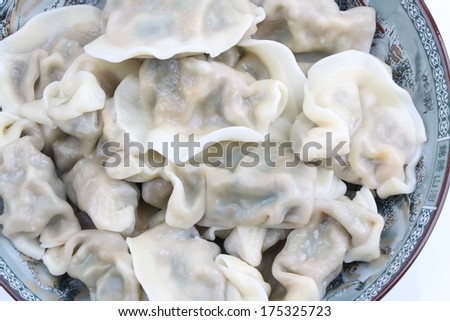 a plate of chinese traditional food dumplings closeup isolated on white background