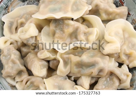 chinese food dumplings in piles isolated on white background