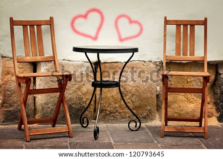 two chairs with hearts on the wall