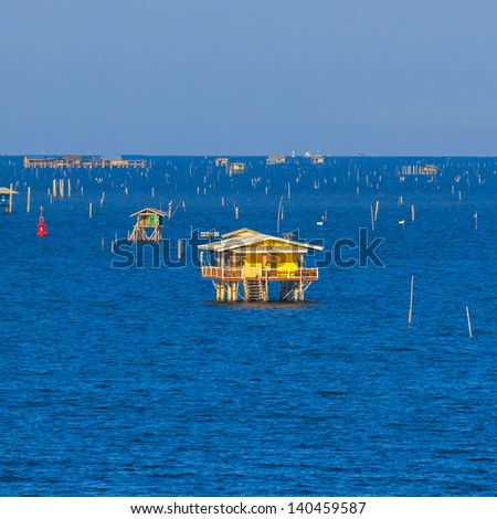 yellow house in deep blue sea of thailand