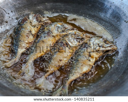 frying mackerel in hot oil and frying pan
