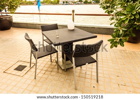 black empty table beside chao praya river, bangkok, thailand