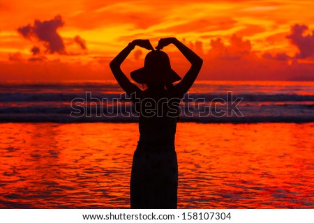 beautiful silhouette woman hand made heart shape, Payam Island, Thailand