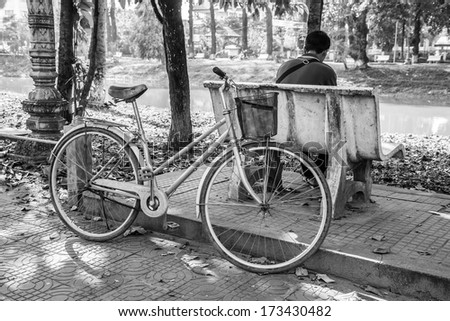 art lonely man and his bicycle at reversed. black and white.