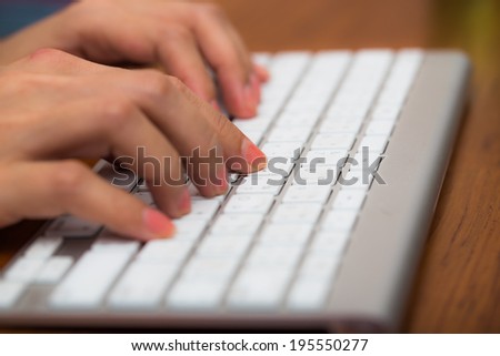 Woman\'s hand typing on computer keyboard