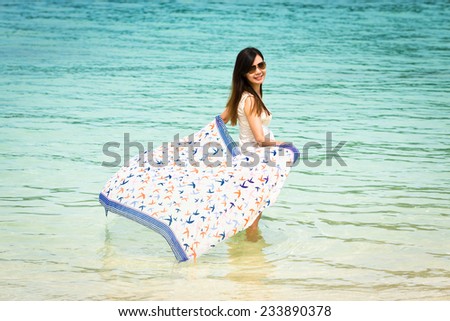 Beautiful Asian girl wading in the sea, Lipe island, Andaman sea, Thailand.