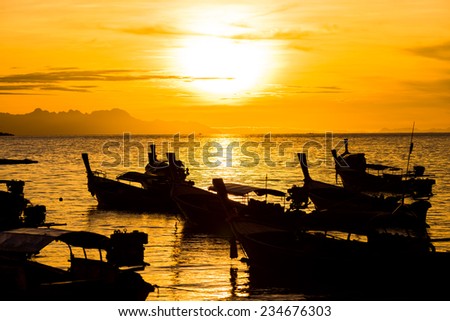 Silhouette fisherman boat with sunrise.