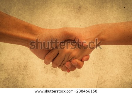 man and woman handshake on white background. grunge paper filter.