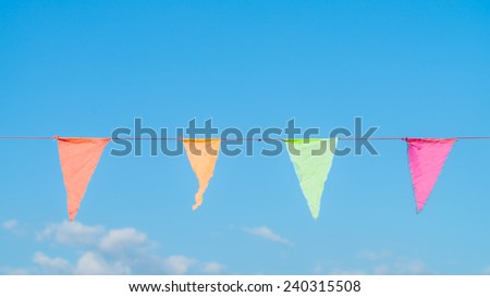 colorful bunting flags against a blue saturated sky