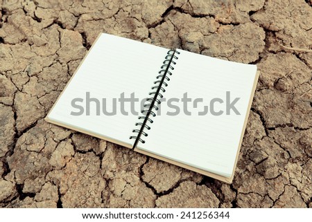 Opened notebook on dry land.