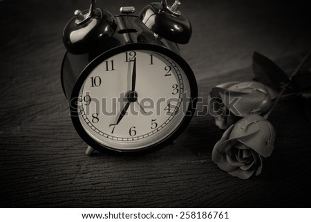 Valentine days background. rose with alarm clock. Black and white effect.