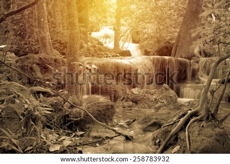 Waterfall in deep rain forest jungle. (Huay Mae Kamin Waterfall in Kanchanaburi Province, Thailand). Vintage filter.