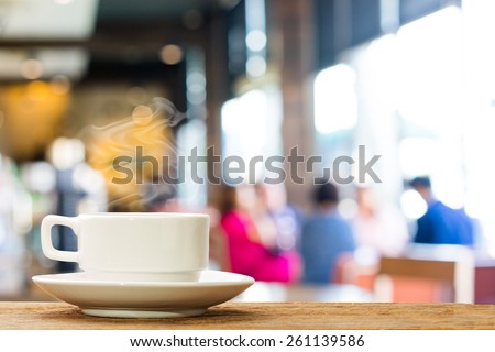 Hot espresso on the table with people do meeting business plan in coffee shop background