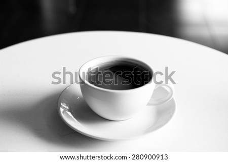 Hot coffee on table. Black and white image.