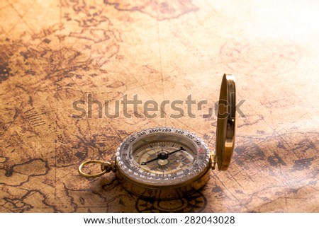 old compass on vintage map.