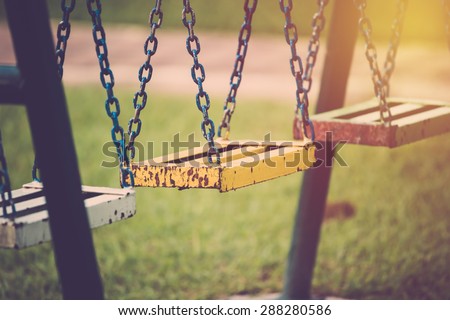 Chain swing in playground. Vintage filter.