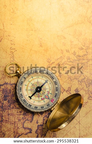 Compass on vintage map. Vintage filter.