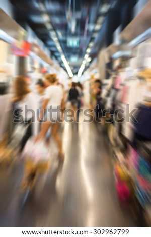 Blur of people shopping in supermarket.