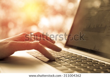 female hands using computer laptop. Vintage filter