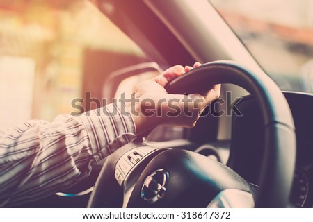 Man hand driving car. Vintage filter